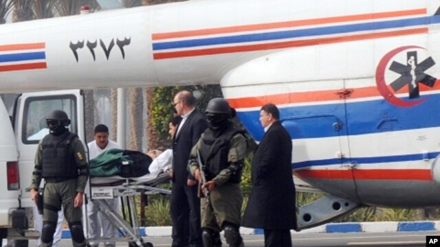 Former Egyptian president Hosni Mubarak is carried from an ambulance to a helicopter for his trial in Cairo, Egypt, Thursday, Jan. 5, 2012.