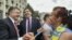 FILE - Ukrainian President Petro Poroshenko (L) and governor of Odessa region Mikheil Saakashvili (C) are greeted by a local resident near the regional state administration in Odessa, May 30, 2015.
