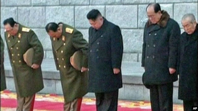 North Korea's new leader Kim Jong Un (C) bows during the funeral of late North Korean leader Kim Jong Il in this still image taken from video, in Pyongyang, December 28, 2011.
