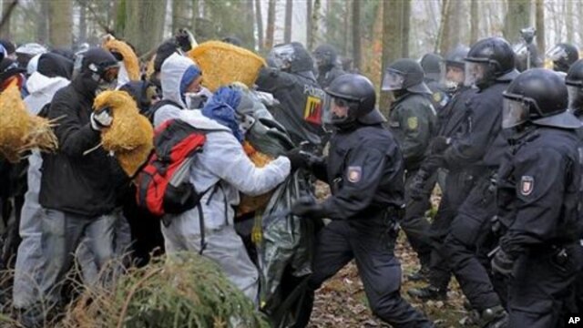 Anti-nuclear activists stand in front of the German riot police during clashes near Leitstade, northern Germany, 07 Nov 2010.