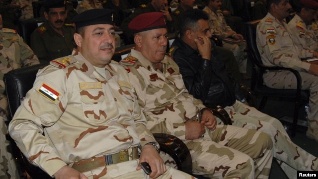 Commander of the army's Seventh Division, Maj. Gen Mohammed Ahmed al-Kurwi, left, attends Ministry of Defence conference, Baghdad Dec. 14, 2013.