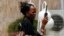 A woman tries to get reception on her mobile phone in Maiduguri, after the military declared a 24-hour curfew over large parts of the city in Borno State May 19, 2013.