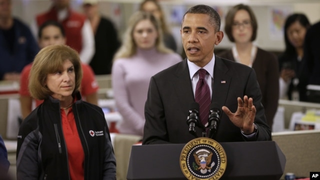 President Barack Obama, accompanied by American Red Cross President and CEO Gail J. McGovern, gestures while speaking during the his visit to the Disaster Operation Center of the Red Cross National Headquarter in Washington D.C. to discuss superstorm Sand