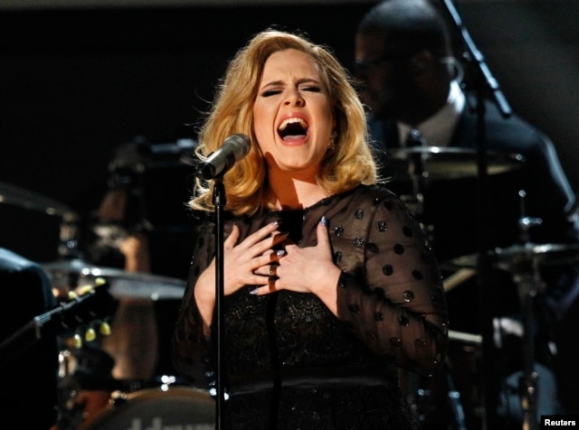 FILE - Adele performs "Rolling in the Deep" at the 54th annual Grammy Awards in Los Angeles, California.