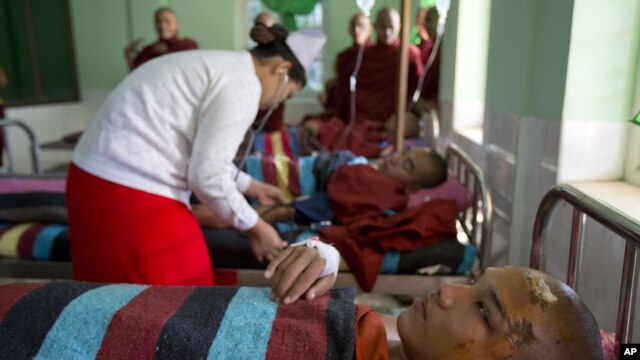 Buddhist monks who suffered burn injuries when security forces cracked down on protesters are treated at a hospital in Monywa town shop, northwestern Burma, Nov. 29, 2012. Security forces used water cannons and other devices to break up the rally hours before opposition leader Aung San Suu Kyi was expected. (AP Photo/Gemunu Amarasinghe)