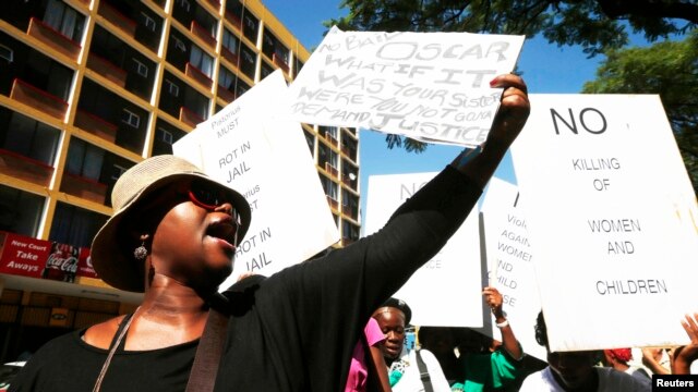Women protest outside the Pretoria Magistrates court, during the bail application hearing of South African athlete Oscar Pistorius, February 19, 2013.