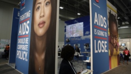 A visitor passes an exhibition at the International AIDS 2012 Conference in Washington