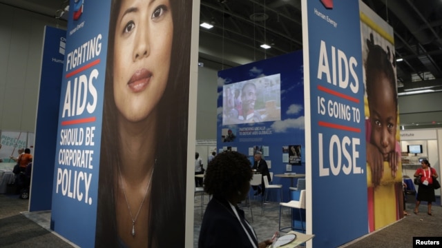 A visitor passes an exhibition at the International AIDS 2012 Conference in Washington