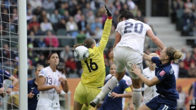 United States' Abby Wambach, center, scores her side's 2nd goal during the semifinal match between France and the United States at the Women�s Soccer World Cup in Moenchengladbach, Germany,  July 13, 2011