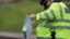 A police officer carries an evidence bag containing a knife near the scene of the killing of a British soldier in Woolwich, London, May 23, 2013. 