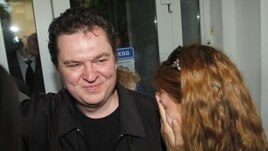Andrzej Poczobut, a correspondent for one of Poland's major newspapers, Gazeta Wyborcza, with his wife Oksana in front of the court building where he was on trial in the town of Grodno, Belarus, July 5, 2011