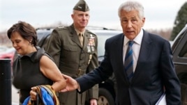 Marine Corp. Lt. Gen. Tom Waldheuser (C) greets Senator Chuck Hagel (R) and his wife Lilibet, as they arrive at the Pentagon for Hagel to be sworn-in as Secretary of Defense, in Arlington, Virginia, Feb. 27, 2013.