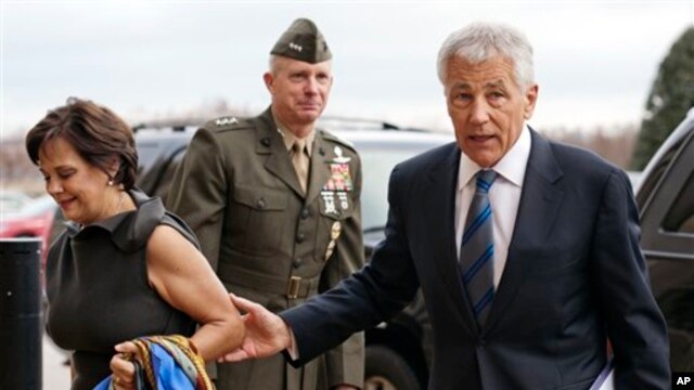 Letjen Marinir AS, Tom Waldheuser (tengah) menyambut Senator Chuck Hagel (kanan) dan istrinya Lilibet, setibanya di Pentagon, Arlington,Virginia  pagi ini (27/2), untuk diambil sumpahnya sebagai Menteri Pertahanan AS.
