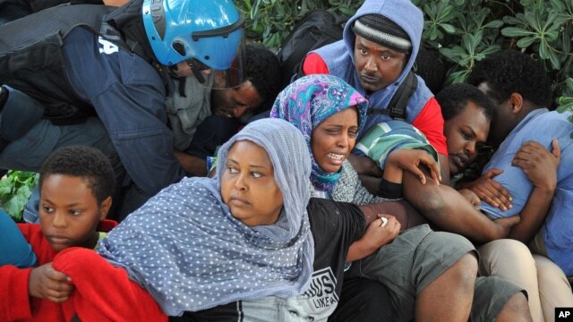 Police in Ventimiglia, Italy drag Eritrean and Sudanese refugees from encampments near the French border last June. Paris officials refused to let them cross into France.