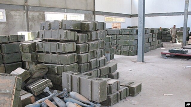 Large mortar shells sit unguarded, and boxes that once held anti-aircraft missiles and other heavy weapons are strewn about arms depots around Tripoli on Wednesday Sept. 7, 2011. Former rebels say they've taken some ammunition for the fight against suppor