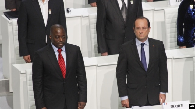 French President Francois Hollande and DRC President Joseph Kabila stand during the opening session of the Francophone Summit, in Kinshasa, DRC, Oct. 13, 2012. 