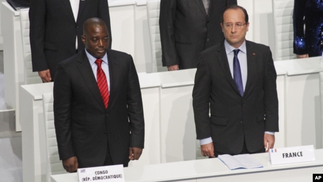 French President Francois Hollande and DRC President Joseph Kabila stand during the opening session of the Francophone Summit, in Kinshasa, DRC, Oct. 13, 2012. 