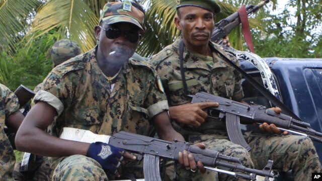 Republican forces troops allied with President Alassane Ouattara drive through the village of Keibly, just outside Blolequin in western Ivory Coast, May 31, 2011.
