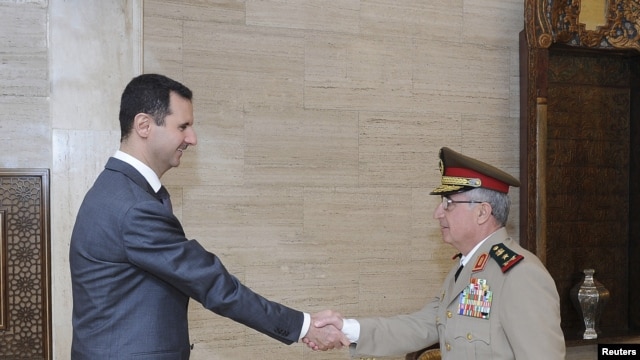 Syria's President Bashar al-Assad (L) welcomes new Chief of General Staff of the Army and the Armed Forces, General Ali Abdullah Ayyoub, before a meeting in Damascus, July 22, 2012.