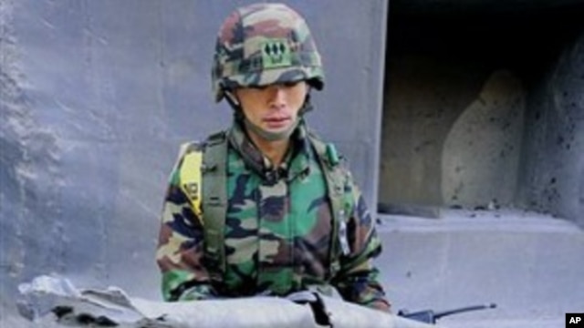 South Korean Marine Lt. Kim Jong-soo shows fragments of shells fired by North Korea to the media on Yeonpyeong island, South Korea, 25 Nov., 2010.