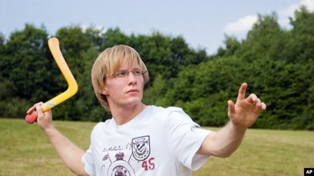 This young man is a boomeranger when it comes to tossing one.  Is he, himself, one as well?