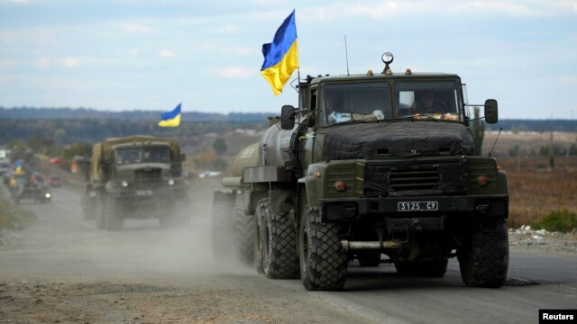 A Ukrainian military convoy moves on the road near the eastern Ukrainian town of Slovyansk, Oct. 5, 2014.  