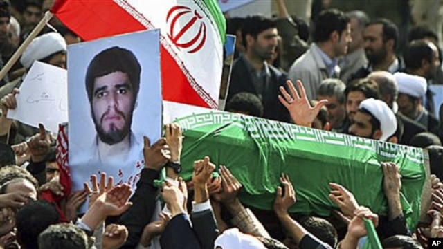 Pro-government Iranians carry the flag-draped coffin of Sane Jaleh, seen in picture at left, a student who was killed during Monday's clashes, in a funeral ceremony in Tehran, Iran, February 16, 2011