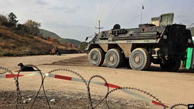 German troops serving in the NATO-led peacekeeping mission in Kosovo patrol near the Serb erected barricade in the village of Zupce, October 26, 2011.
