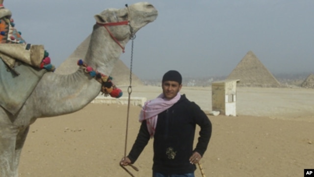 Mahmoud Adal and his camel await tourists in Giza, Egypt.