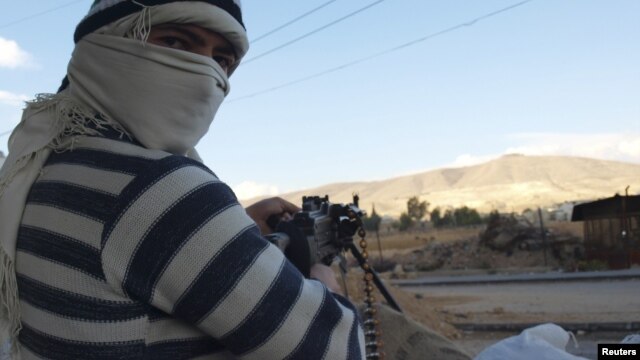 Free Syrian Army fighters are seen in Daria near Damascus, Syria, November 25, 2012.