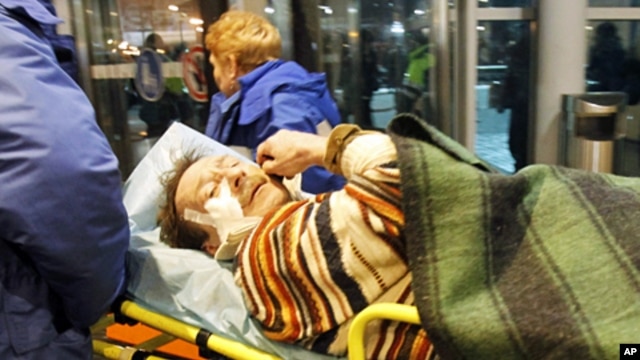 Medics wheel a victim of a bomb explosion at Moscow's Domodedovo airport, 24 Jan 2011