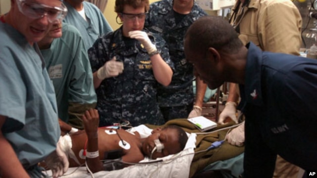 Medical professionals aboard the Military Sealift Command hospital ship USNS Comfort treat a six-year-old Haitian boy in the casualty receiving room aboard the 1,000-bed hospital ship, 19 Jan 2010