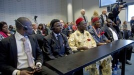 Plaintiffs Alali Efanga, Friday Alfrad Akpan, Chief Fidelis A. Oguru, Eric Dooh, and lawyer Chima Williams wait for the start of a court case against Shell, in The Hague, October 11, 2012.