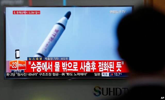 A man watches a TV news program showing a file footage of a missile launch conducted by North Korea, at the Seoul Train Station in Seoul, South Korea, April 23, 2016.