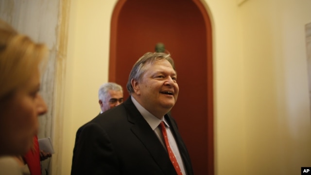 Socialist leader Evangelos Venizelos, walks inside the Parliament building after meeting with Greece's conservative election victor Antonis Samaras in Athens Monday, June 18 2012. 