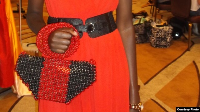 Model poses with a handbag made from recycled paper and beads by Cameroon businesswoman Jacqueline Kamsu. (Kamsu)