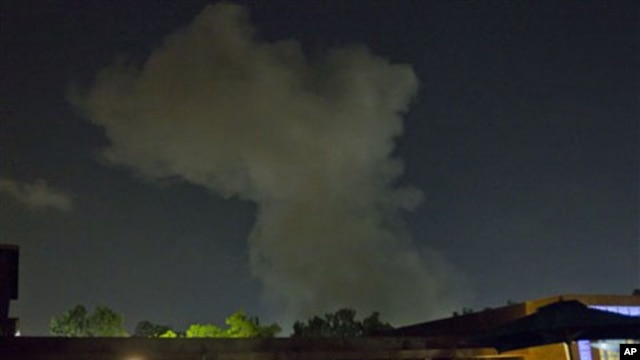 A plume of smoke rises following an late-night airstrike in Tripoli, Libya, May 24, 2011