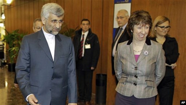 EU foreign policy chief Catherine Ashton, right, greets Saeed Jalili, Iran's chief negotiator in the foyer of the conference center near the Swiss mission to the United Nations in Geneva, 06 Dec. 2010