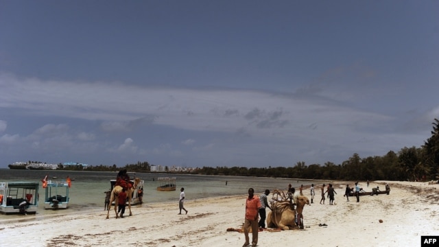 Local tourists walk at the Kenyatta public beach on August 30, 2012, in Mombasa, Kenya.