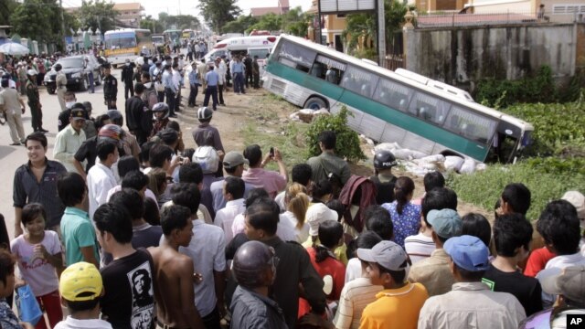 FILE - In this 2009 photo, crowds of people watch after a bus collided with a motorcycle on the outskirts of Phnom Penh, Cambodia. Traffic accidents are the leading cause of death in Cambodia, a road safety expert told the Hello VOA call-in program on June 29, 2016.