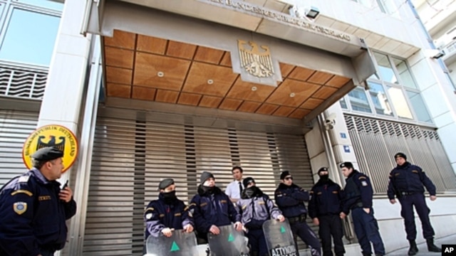Riot police secure the entrance to the German Embassy during an anti-austerity protest in Athens, February 17, 2012.
