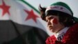 A girl wears a headband in the colors of the Syrian revolutionary flag during a protest in front of the Syrian embassy in Amman, Jordan, May 17, 2013.