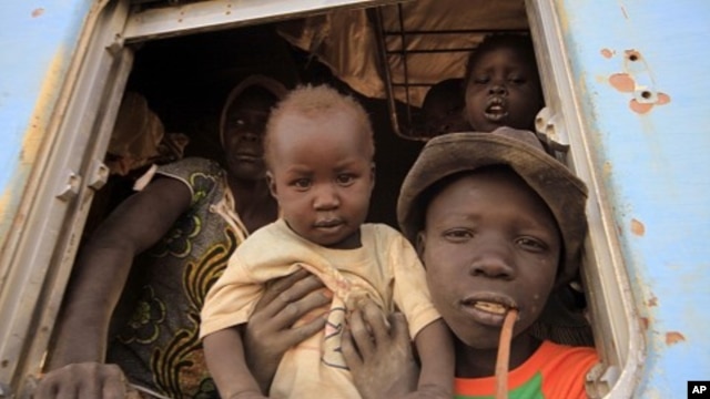 A South Sudanese family waits inside a train in Khartoum to be transported to Wau in South Sudan, March 1, 2012. 