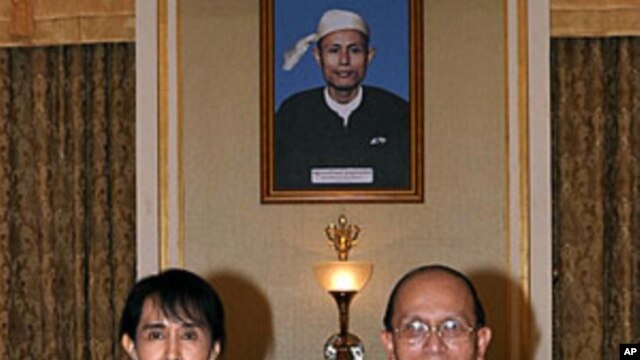 Burma's democracy icon Aung San Suu Kyi and President Thein Sein pose for photos before their meeting at the presidential office in Naypyitaw, August 19, 2011