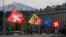 FILE - Swiss and Canton of Geneva flags are seen flying on the Mont-Blanc bridge in Geneva, Switzerland, Oct. 11, 2016. Swiss lawmakers plan to submit to government a new broad EU treaty that would replace patchwork of bilateral deals now under strain from immigration.