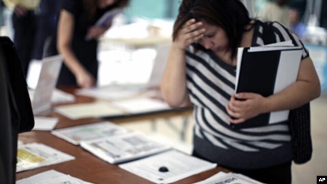 A woman browses job openings at a job fair in Los Angeles, California, (File)
