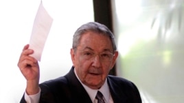 Cuba's President Raul Castro holds up the ballot of his brother Fidel, also present in the session,  for president of the National Assembly during the opening session of the parliament in Havana, Cuba, Feb. 24, 2012.  