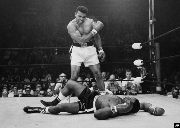 FILE - Heavyweight champion Muhammad Ali stands over fallen challenger Sonny Liston, shouting and gesturing shortly after dropping Liston with a short hard right to the jaw, in Lewiston, Maine, May 25, 1965.