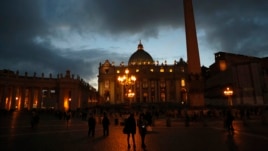 People walk in Saint Peter's Square at the Vatican, March 7, 2013.