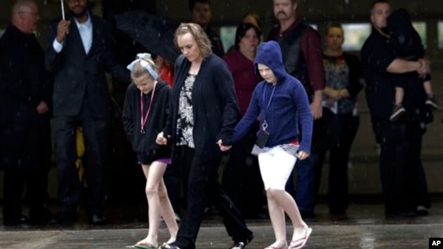 Mourners leave funeral service for Antonia Calendaria, 9, who was killed by Monday's tornado May 23, 2013 in Oklahoma City, Oklahoma